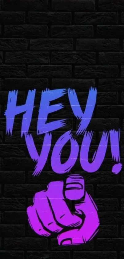 Graffiti style 'Hey You!' on a dark brick wall.