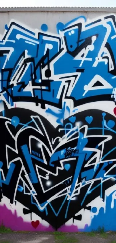 Blue and black graffiti heart on urban wall art.