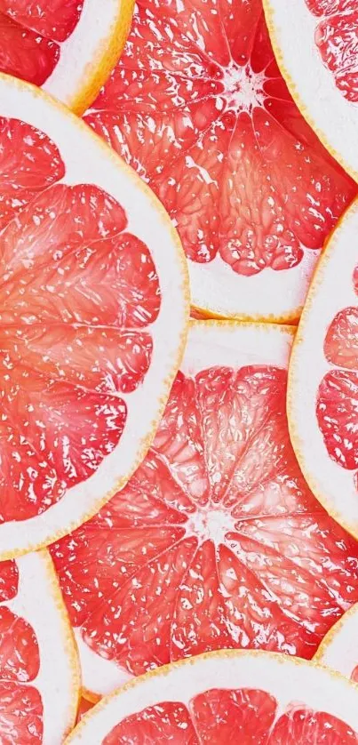 Mobile wallpaper with sliced grapefruits in vivid red-orange hues.