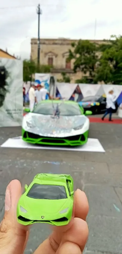 Lime green sports cars at an outdoor event, blending model and full-size views.