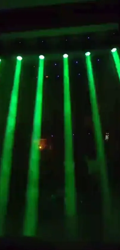 Green laser beams on a dark background