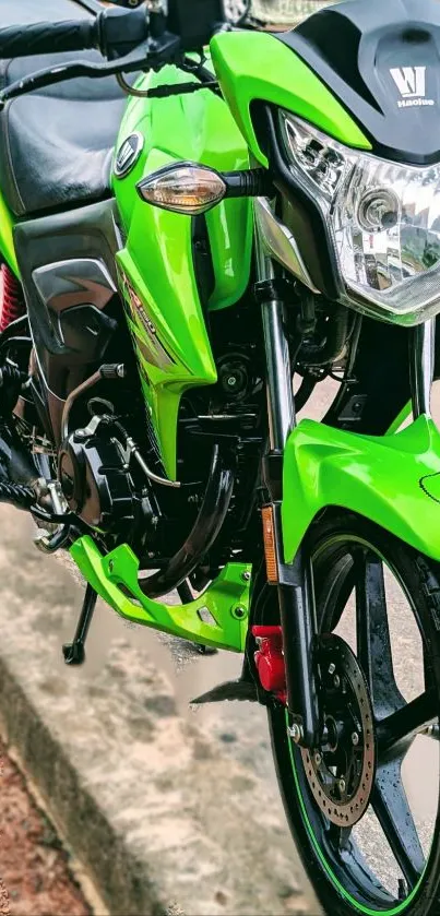 Green motorcycle on a street sidewalk, showcasing sleek design.