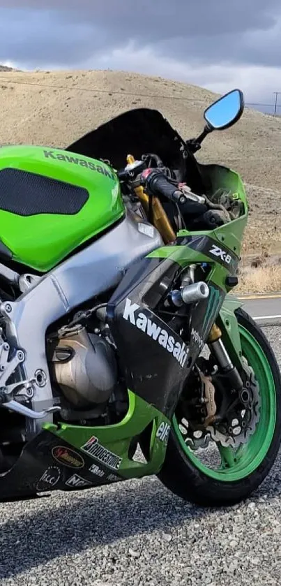 Green Kawasaki motorcycle on desert road.