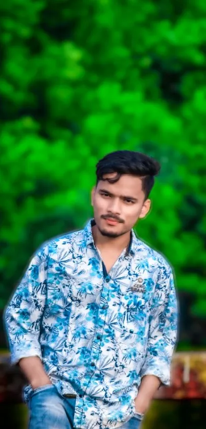 Person in floral shirt standing before vibrant green foliage.