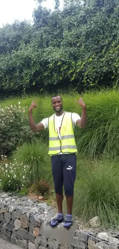 Person in garden with lush green background wearing a yellow vest.