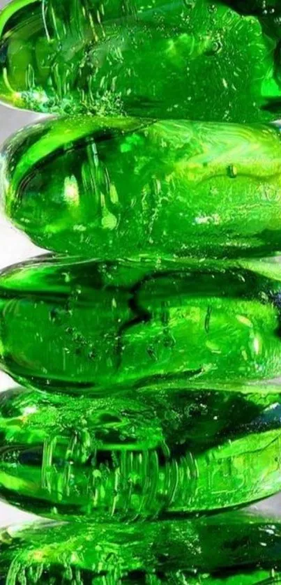 Stack of vibrant green pebbles on a reflective surface.