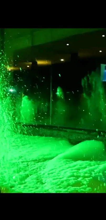 Neon green water fountain glowing at night.