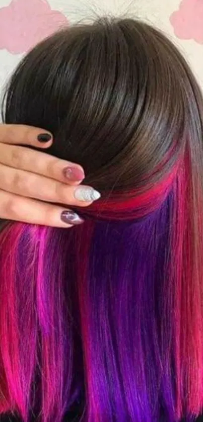 Vibrant hair with pink and purple streaks.