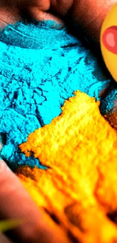 Hand holding vibrant blue and yellow powder, with a heart eyes emoji.
