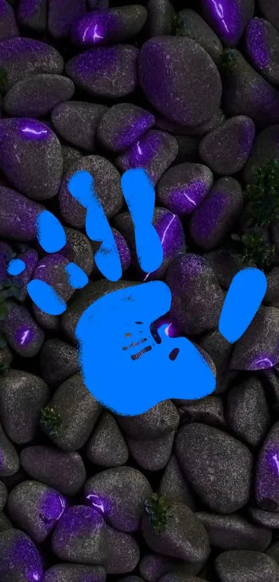 Blue handprint on purple-accented pebbles wallpaper.