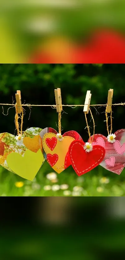 Vibrant hearts hanging on string against lush green background.