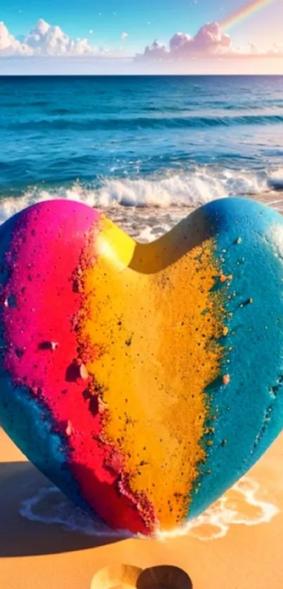 Colorful heart-shaped rock on a scenic beach at sunset with ocean waves.