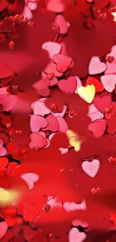 Vibrant red and pink heart confetti wallpaper with yellow accents.