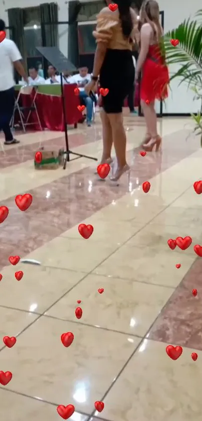 Dance floor with floating red hearts and elegant attendees.