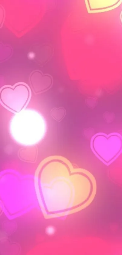 Vibrant pink heart mobile wallpaper with glowing hearts.