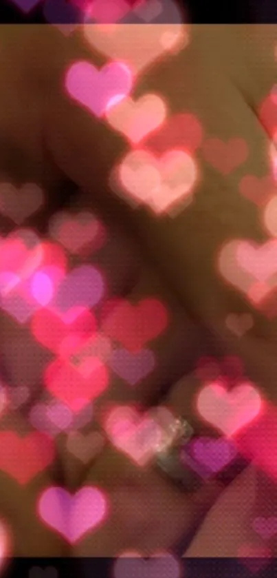 Mobile wallpaper with a glowing pink heart bokeh effect.