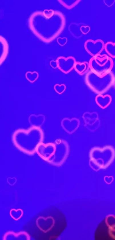 Vibrant wallpaper with glowing hearts in pink and orange on a purple background.