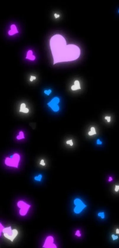 Colorful neon heart wallpaper with pink, blue, and white hearts on a black background.