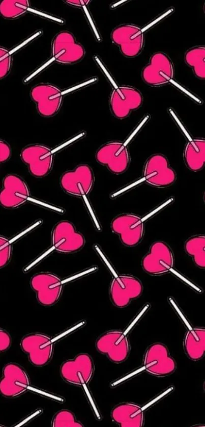 Bold black wallpaper with pink heart lollipops.