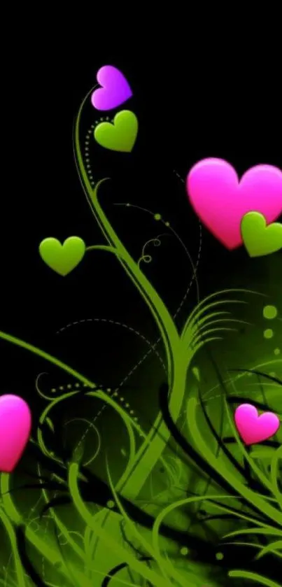 Vibrant wallpaper with pink and green hearts on a black background.