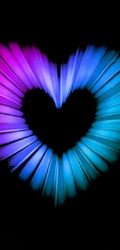 Neon heart with pink and blue hues on a black background.