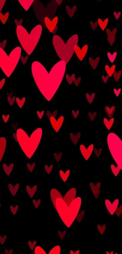 Vibrant red and pink hearts on a black background wallpaper.