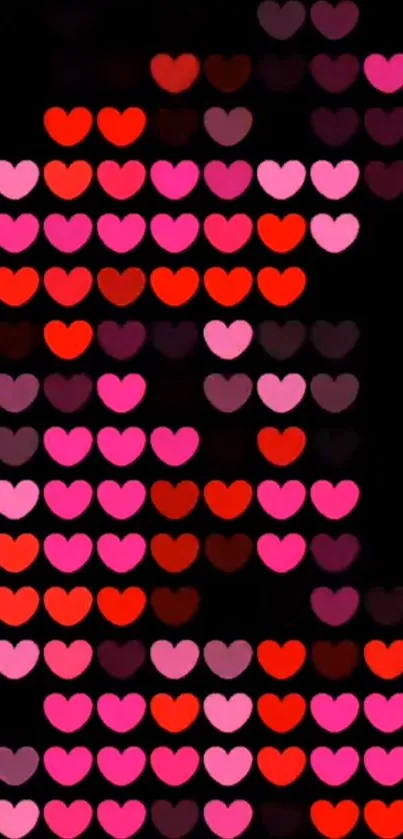 Vibrant red and pink hearts on a black background wallpaper.