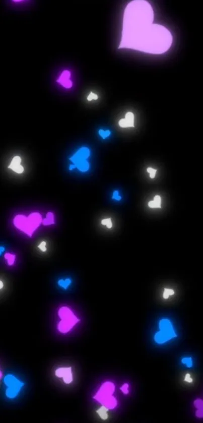 Colorful heart pattern wallpaper in pink, blue, and white on a black background.