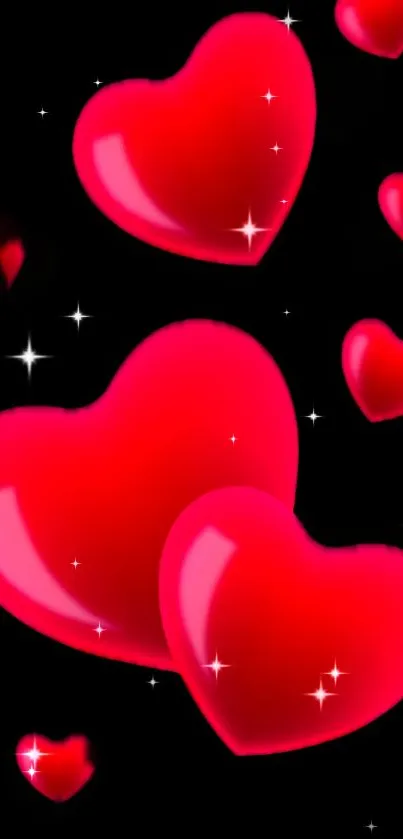 Glossy red hearts with sparkles on a black background wallpaper.