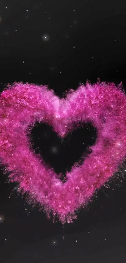 Exploding pink heart on black background wallpaper.