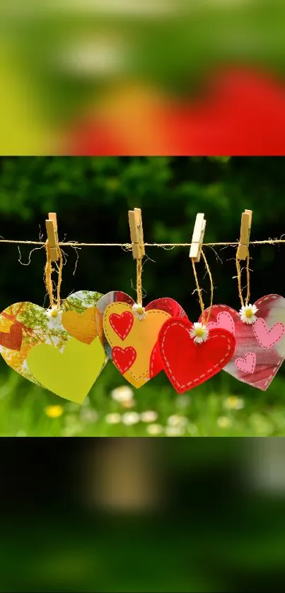 Vibrant hearts hang on a clothesline with a green nature background.