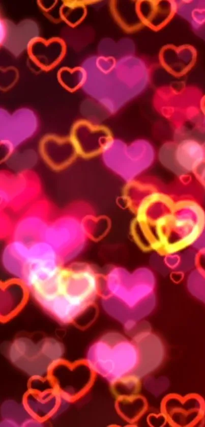 Vibrant bokeh with hearts in red and pink tones for mobile wallpaper.