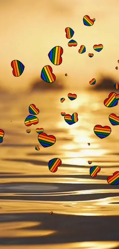 Colorful heart balloons float over a golden sunset on the ocean.