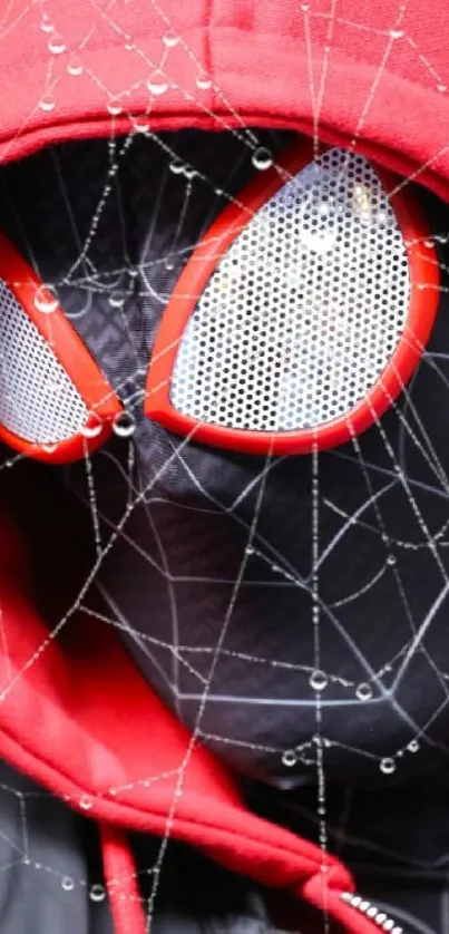 Close-up of masked figure in red hood with web details.