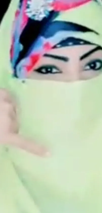 Woman with vibrant hijab, intricate patterns, and expressive eyes.