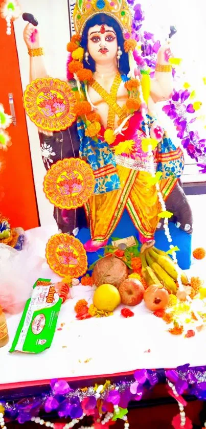 Colorful Hindu deity with offerings and floral decor.