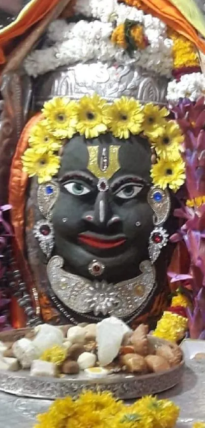 Vibrant Hindu deity shrine adorned with colorful garlands and offerings.