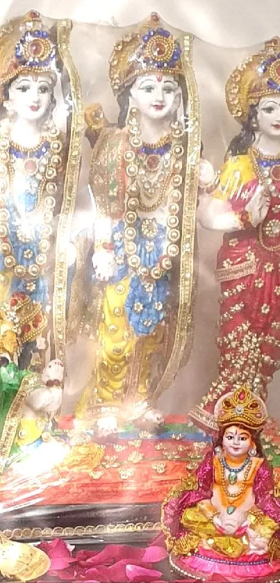 Statues of Hindu deities with vibrant colors and jewelry.