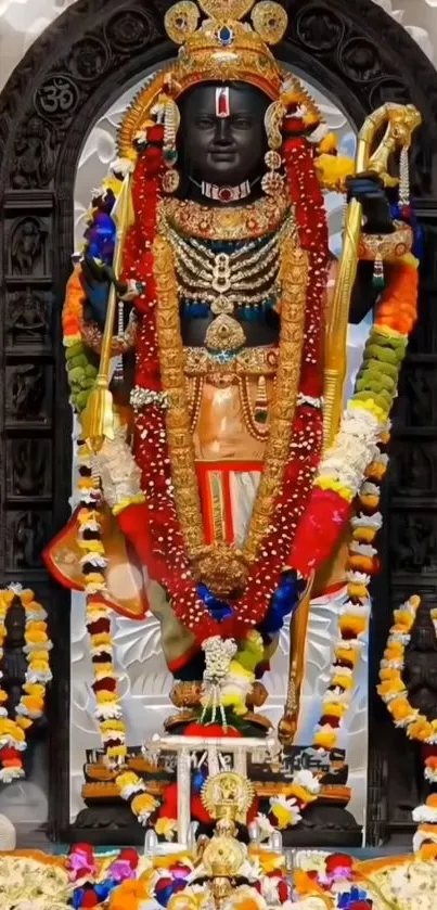 Hindu deity adorned with colorful garlands and ornate jewelry in temple setting.