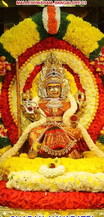 Hindu goddess surrounded by vibrant floral decorations.