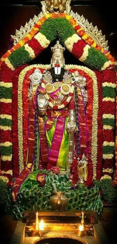 Hindu temple decor with vibrant floral garlands and intricate religious statue.