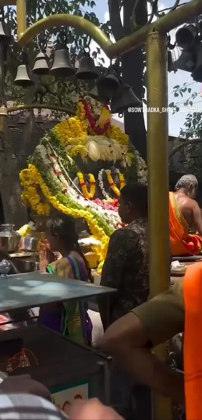 Hindu temple with devotees and floral decorations.