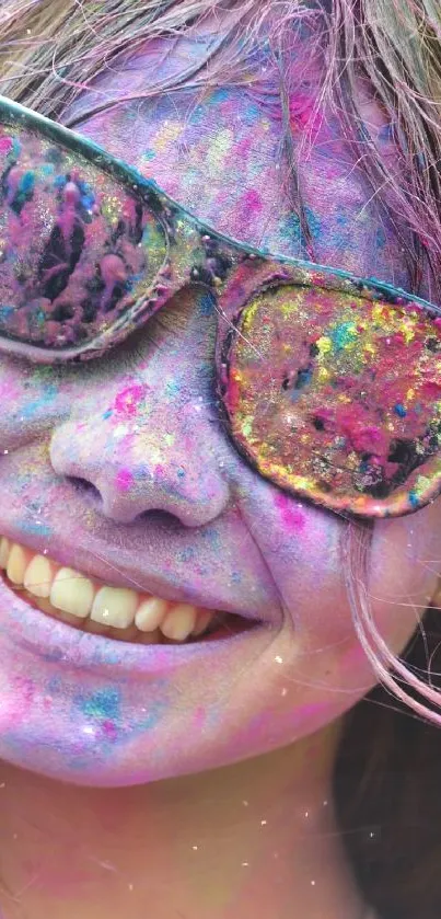 Joyful face with colored Holi festival splashes wearing sunglasses.