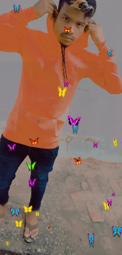 Person in an orange hoodie with colorful butterflies around.