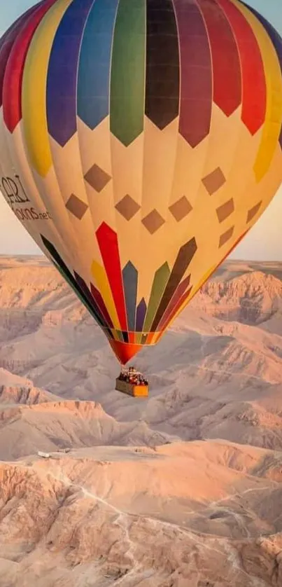 Colorful hot air balloon over desert landscape.