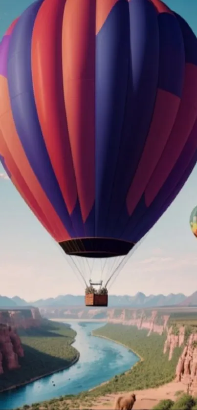 Hot air balloon floats over canyon landscape with river and clear skies.