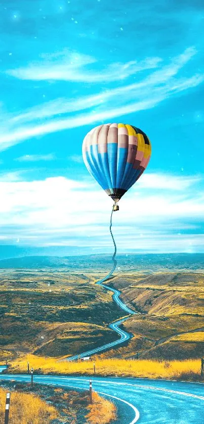 Vibrant balloon over a winding road and blue sky.