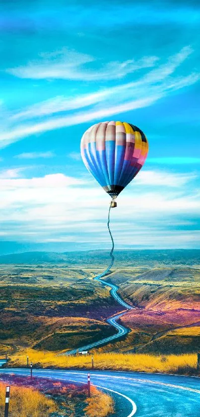 Hot air balloon over scenic road under a vibrant blue sky.