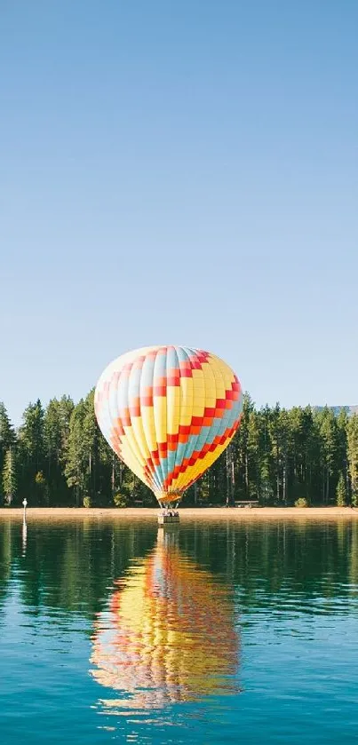 Colorful hot air balloon over a calm lake with clear sky