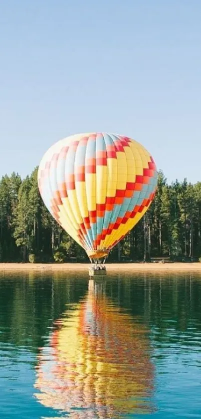 Colorful hot air balloon over a reflective lake in a forest setting.